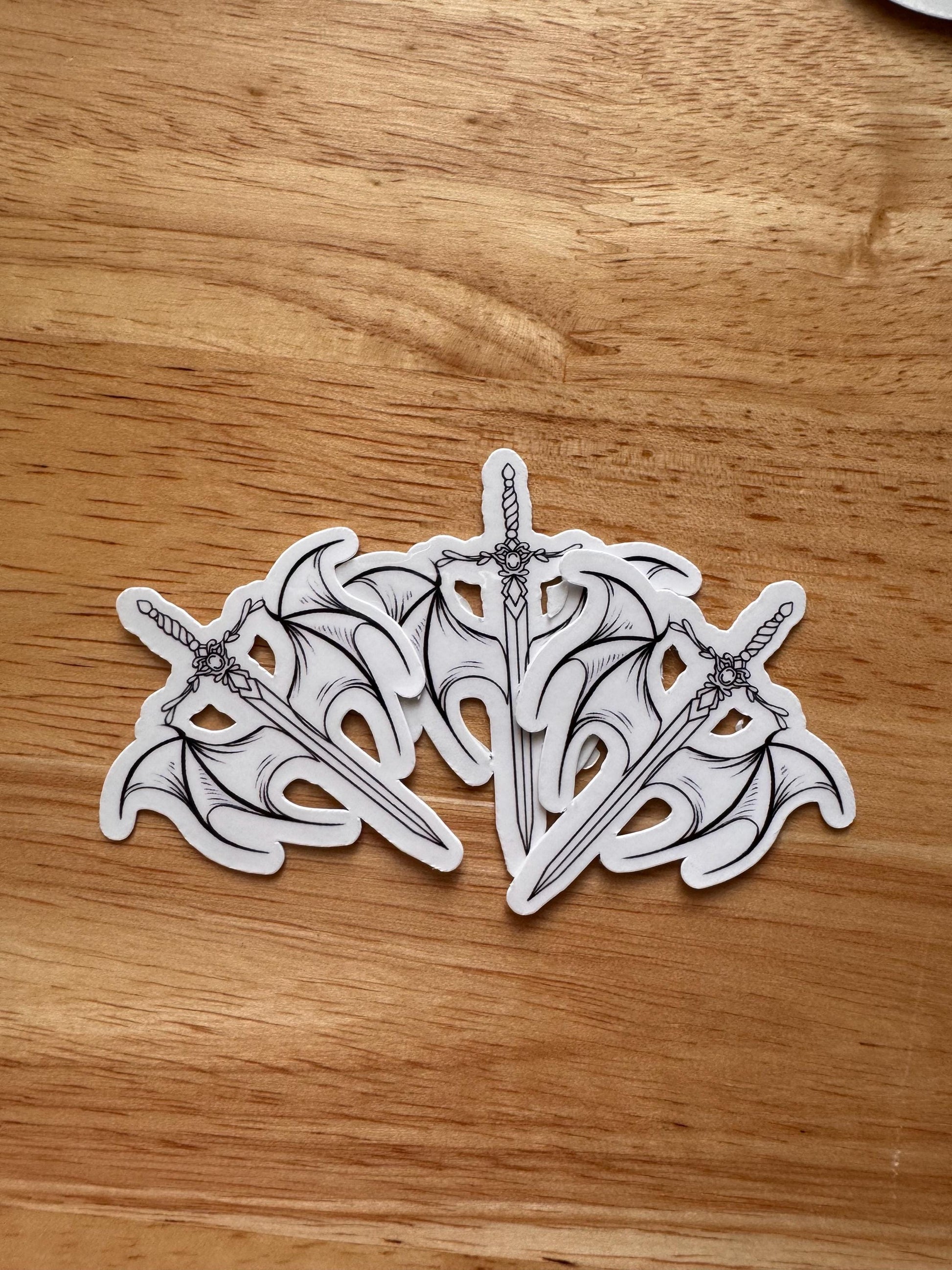 Winged Sword Fantasy Sticker | Romantasy Vinyl Decal for Book Lovers | Celestial Aesthetic Laptop Sticker | Light vs Dark Symbolism Gift | Mystical Bookish Accessory - The Sticker Era
