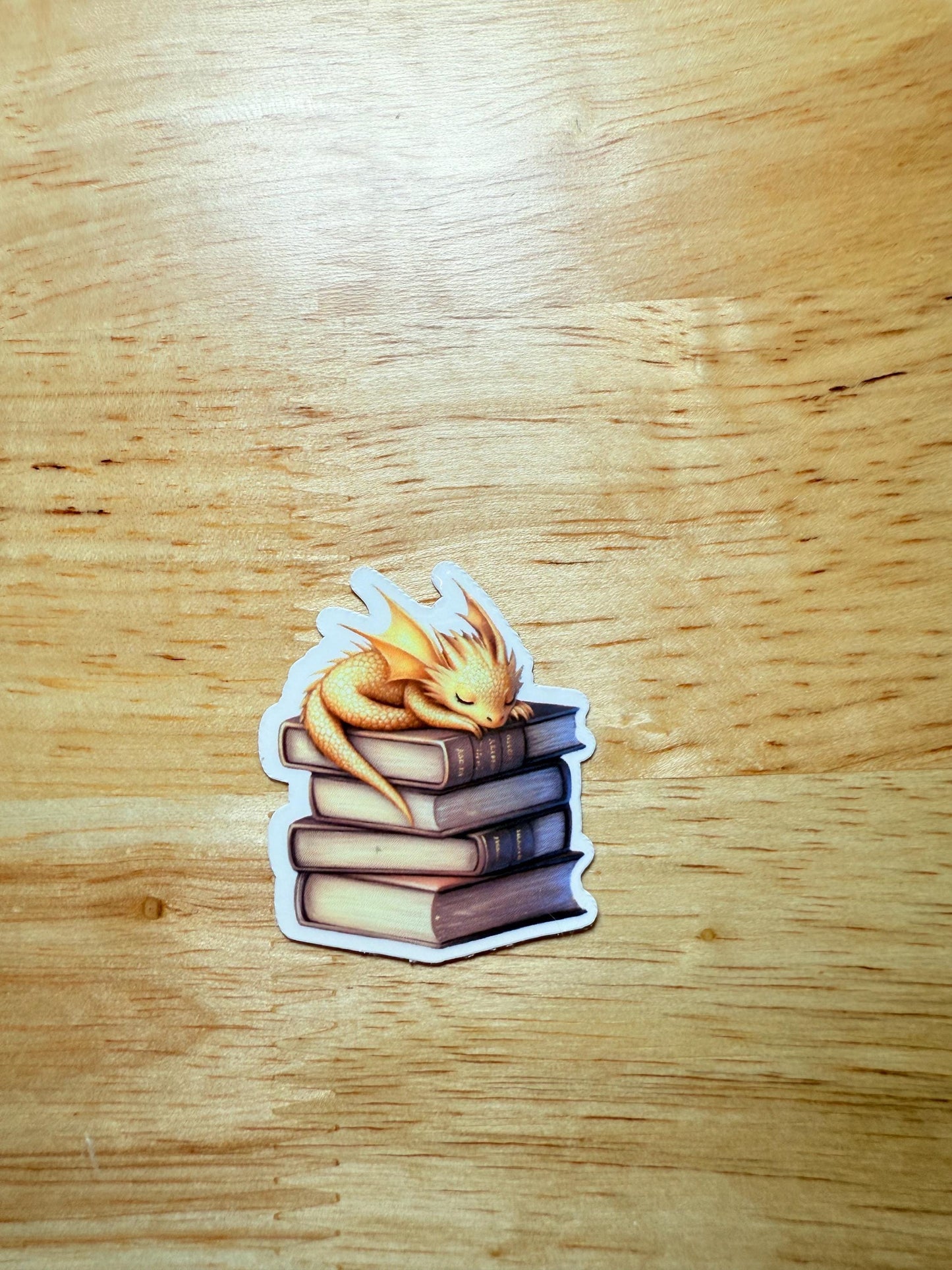 Andarna Inspired Dragon Sticker | Gold Dragon Sleeping on Books Vinyl Decal | Romantasy Booktok Gift | Cozy Fantasy Reader Laptop Sticker | Book Lover Accessory - The Sticker Era