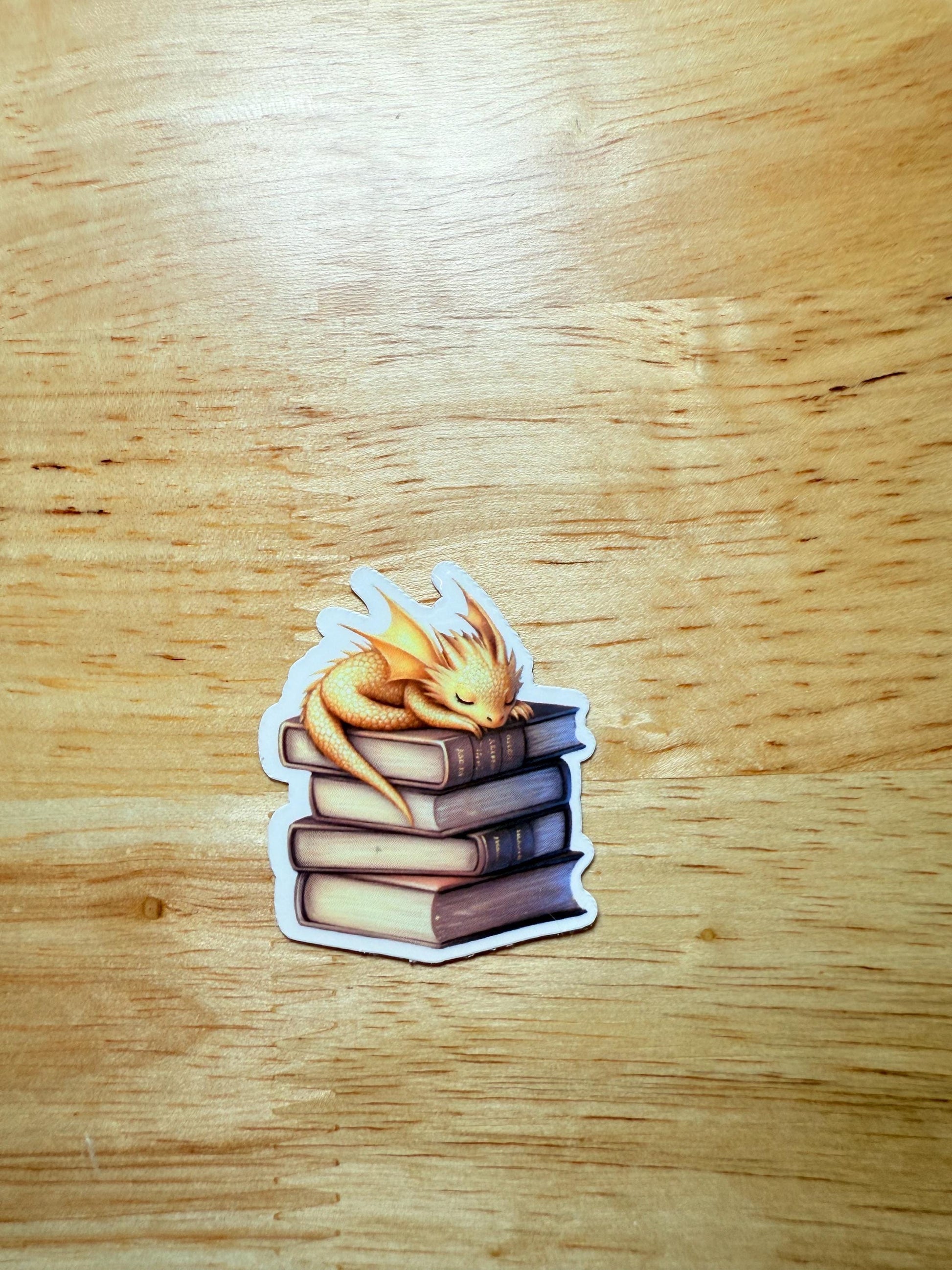 Andarna Inspired Dragon Sticker | Gold Dragon Sleeping on Books Vinyl Decal | Romantasy Booktok Gift | Cozy Fantasy Reader Laptop Sticker | Book Lover Accessory - The Sticker Era