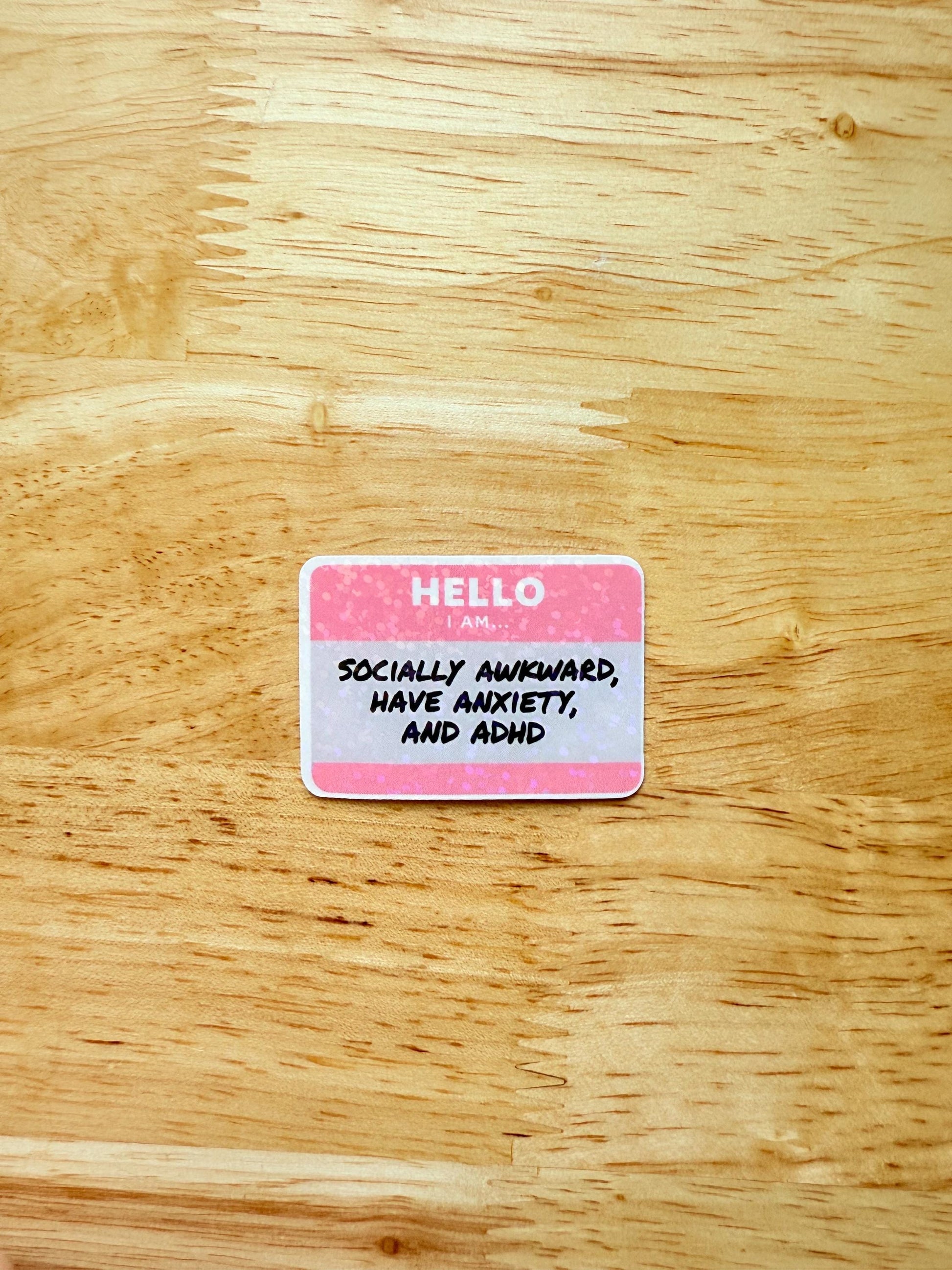 A pink vinyl sticker with the phrase “Socially Awkward, Have Anxiety, and ADHD.” Great for mental health awareness, relatable humor, and introvert aesthet