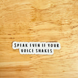 Speak Even If Your Voice Shakes" vinyl sticker on a wooden surface