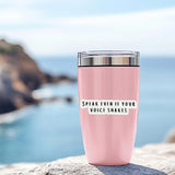 Speak Even If Your Voice Shakes" sticker on a pink tumbler by the ocean