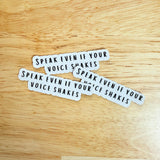 Three "Speak Even If Your Voice Shakes" empowerment stickers on a wooden background