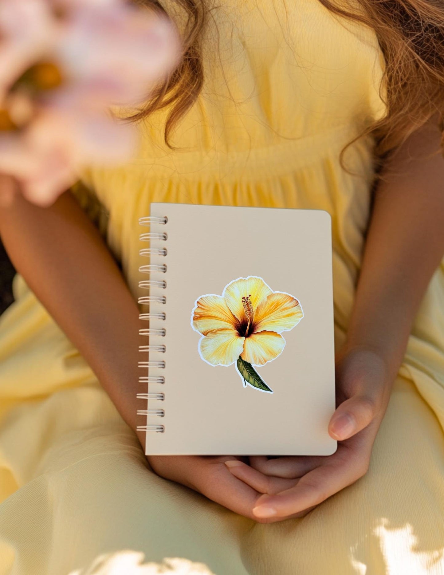A bright yellow hibiscus flower vinyl sticker, perfect for tropical, beach-themed journals, laptops, and water bottles.