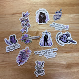 All 11 Powerless-inspired romantasy vinyl stickers laid out on wood — daggers, butterfly, and Kai Azer quotes, by The Sticker Era