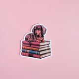 Dachshund on Books Sticker | Cute Bookish Dog Vinyl Decal by The Sticker Era