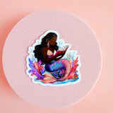 Bookish Black mermaid reading siren sticker close-up, by The Sticker Era