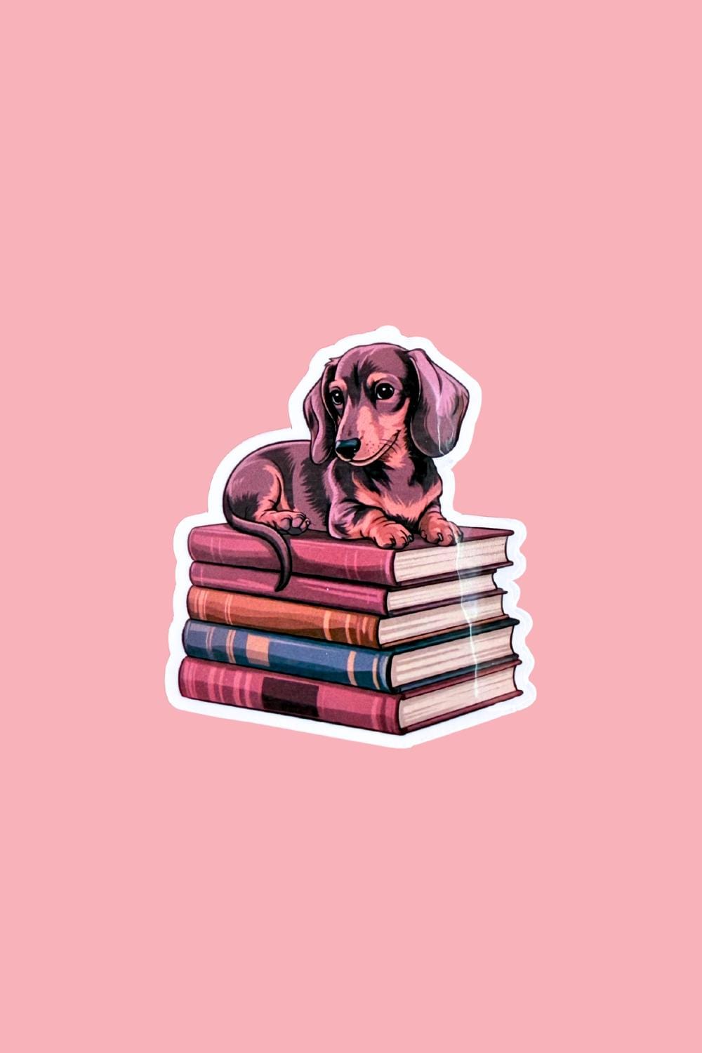 Dachshund on Books Sticker | Cute Bookish Dog Vinyl Decal by The Sticker Era