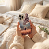 Fantasy reader holding a dragon rider iPhone insert in a cozy bed setting by The Sticker Era