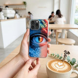Romantasy reader holding a dragon eye iPhone insert beside a latte by The Sticker Era