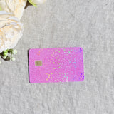 Light pink glitter card skin with holographic sparkle on a baby pink debit card by The Sticker Era