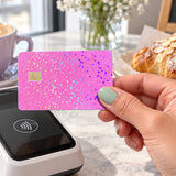 Pink glitter card skin tapping a card reader at a coffee shop by The Sticker Era