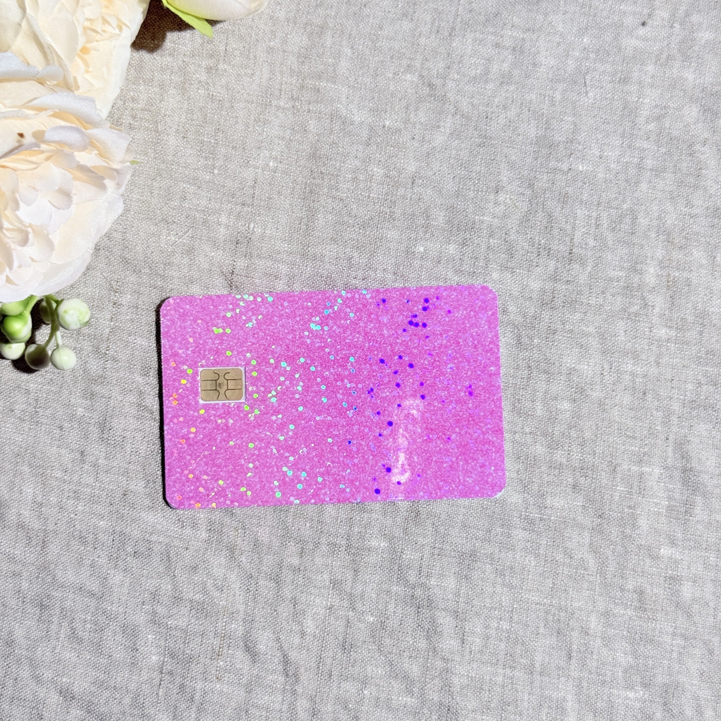 Baby pink sparkle card skin catching rainbow light by The Sticker Era