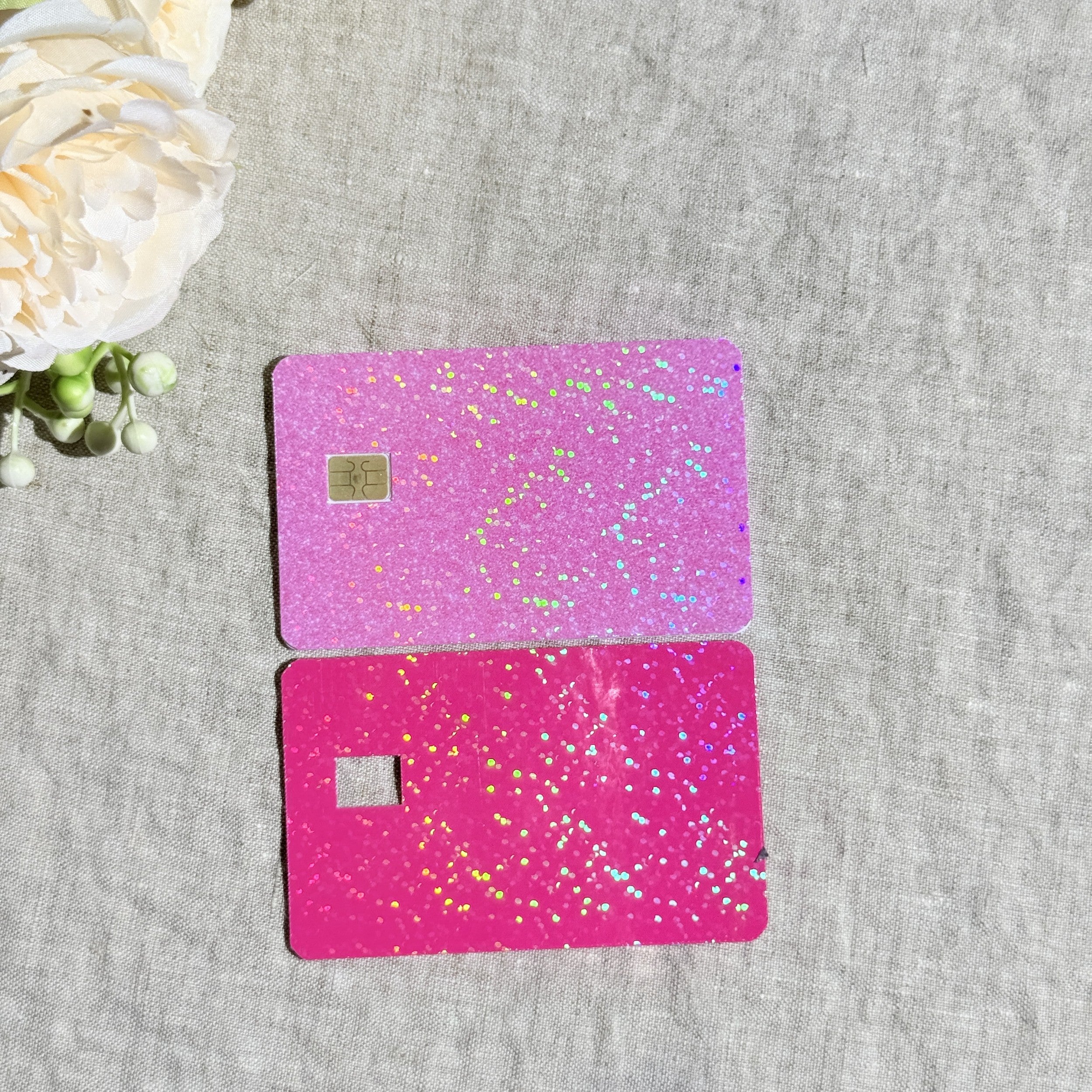 Light pink and hot pink glitter card skins side by side on linen by The Sticker Era