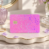 Pink glitter card skin on a scalloped trinket dish with perfume and a gold ring by The Sticker Era