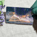 Magic book card skin on a debit card in a wallet by The Sticker Era