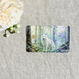 White wolf in the forest card skin flat lay on cream linen by The Sticker Era