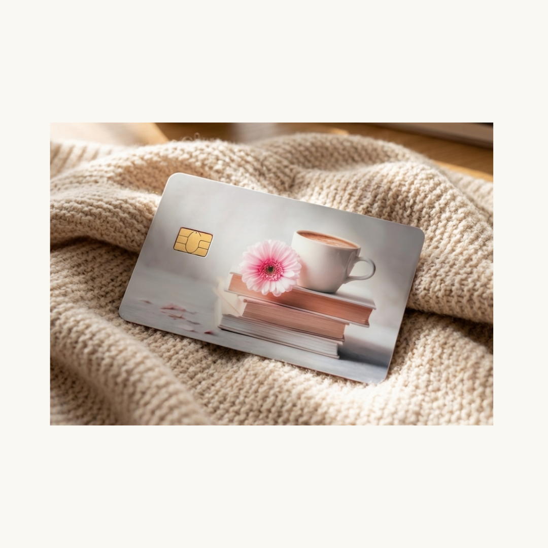 Books and coffee floral card skin with pink daisy and stacked books, romantasy reader card decal by The Sticker Era