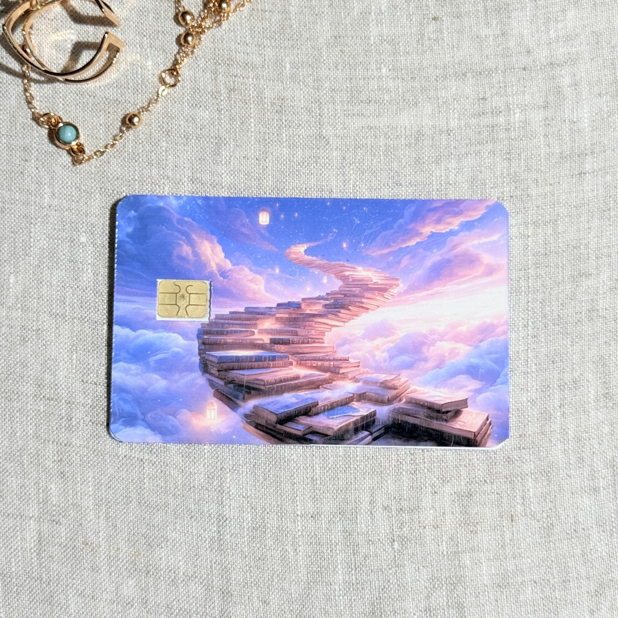 Dreamy sky book staircase debit card sticker shown flat on linen
