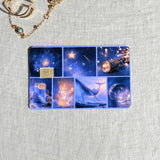 Celestial collage card skin on a debit card, blue grid of telescopes whales and stars