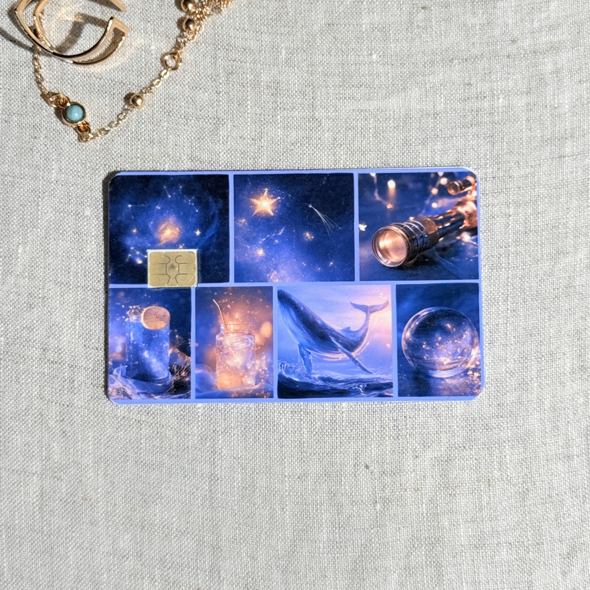 Celestial collage card skin on a debit card, blue grid of telescopes whales and stars