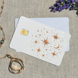 Copper constellation debit card sticker shown flat on linen