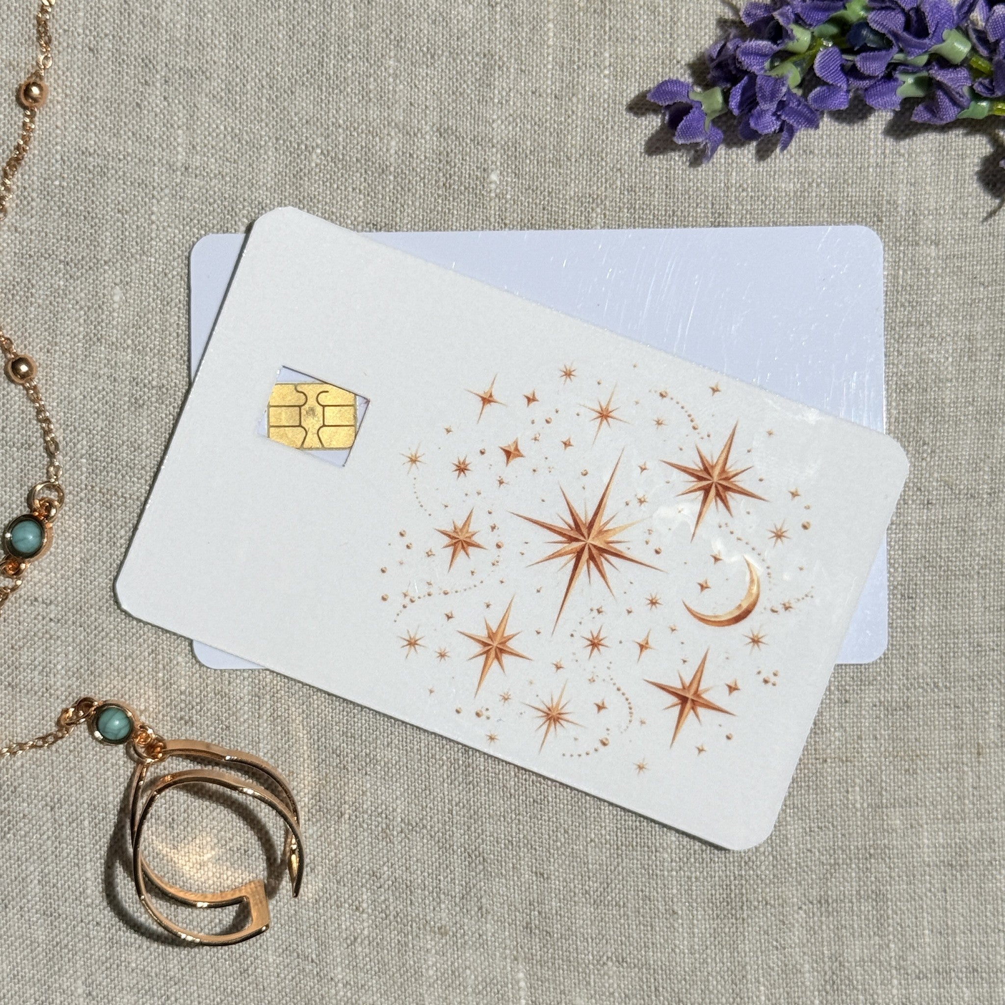 Two celestial stars card skins stacked to show the standard and sparkle finishes