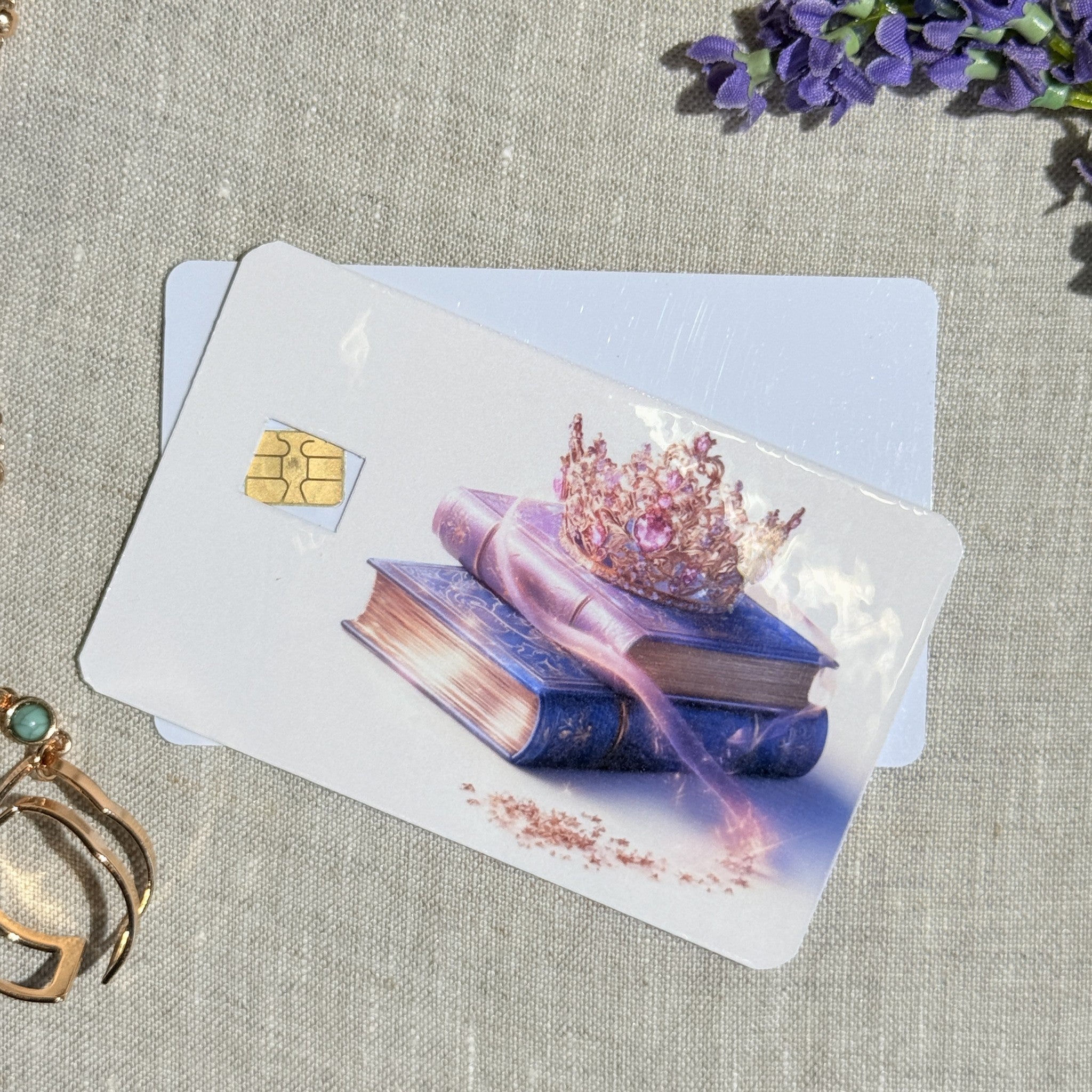 Two crown and books card skins stacked to show the standard and sparkle finishes