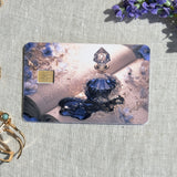 Blue bottle and open book debit card sticker shown flat on linen