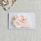 Peony card skin on a debit card, a single sculpted blush peony on clean white