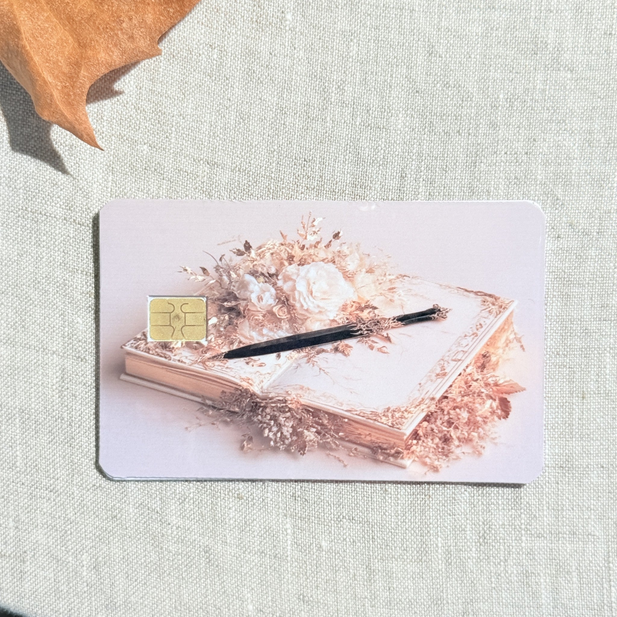 Blush writer debit card sticker shown flat on linen