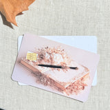 Two quill and roses card skins stacked to show the standard and sparkle finishes
