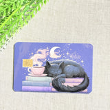 Moonlit books and tea debit card sticker shown flat on linen