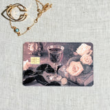 Dark romance goblet debit card sticker shown flat on linen
