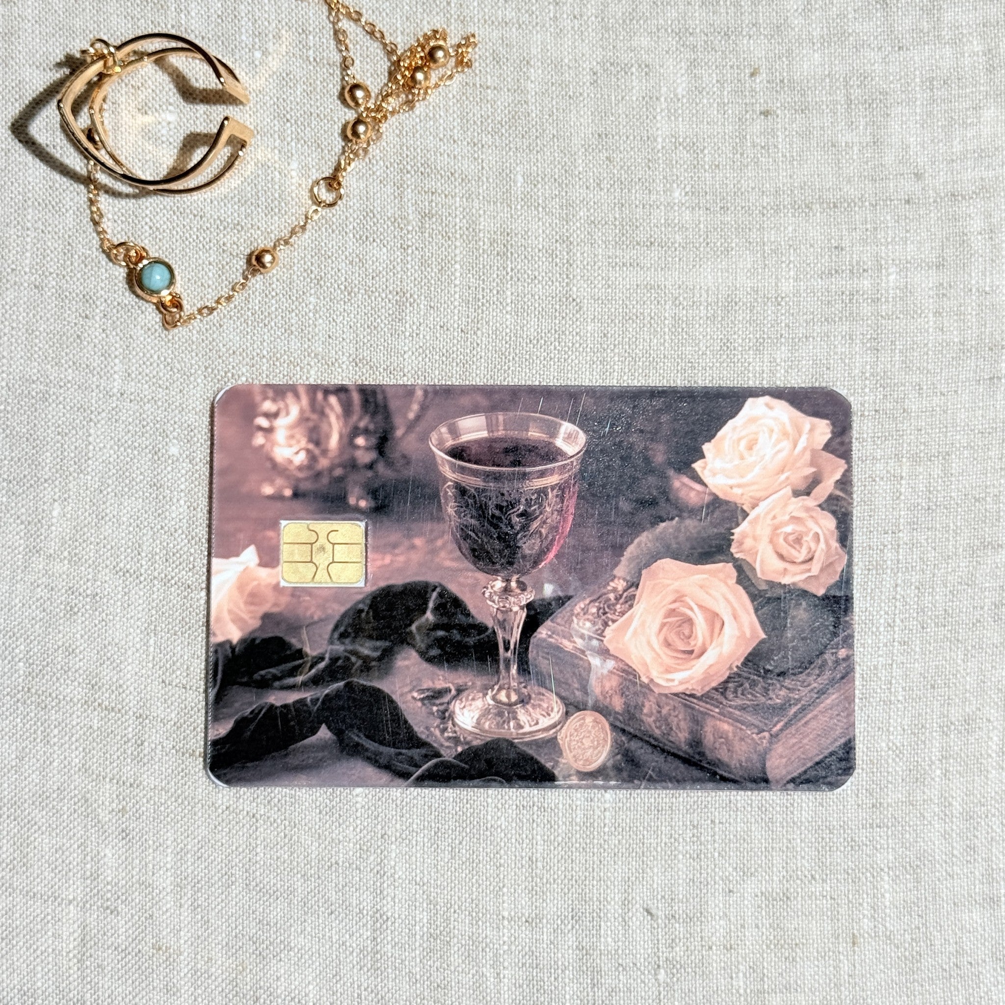 Dark romance goblet debit card sticker shown flat on linen