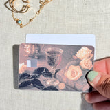 Two wine and roses card skins stacked to show the standard and sparkle finishes