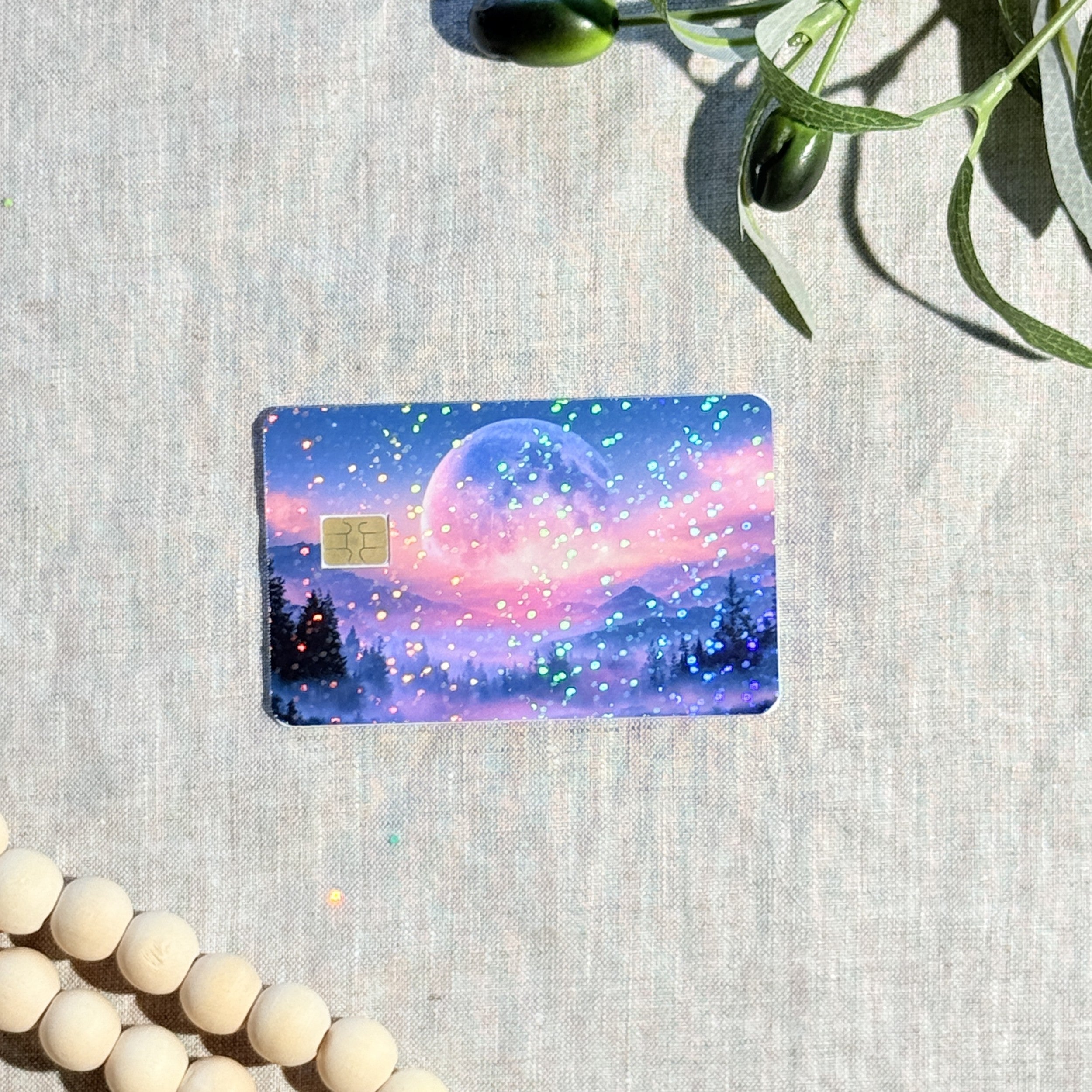 Pink sunset moon card skin flat lay on cream linen by The Sticker Era