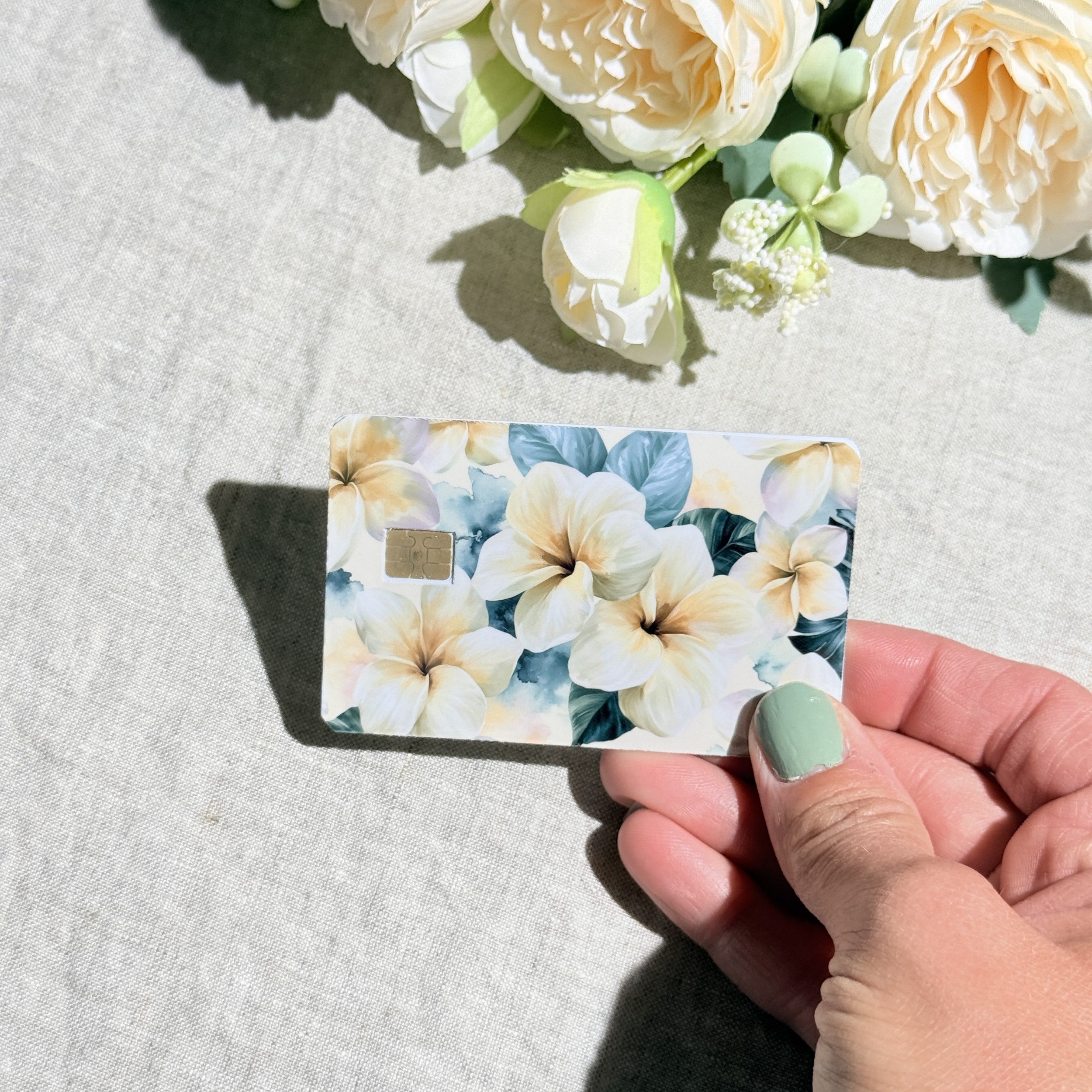 Tropical floral card skin held at an angle by The Sticker Era
