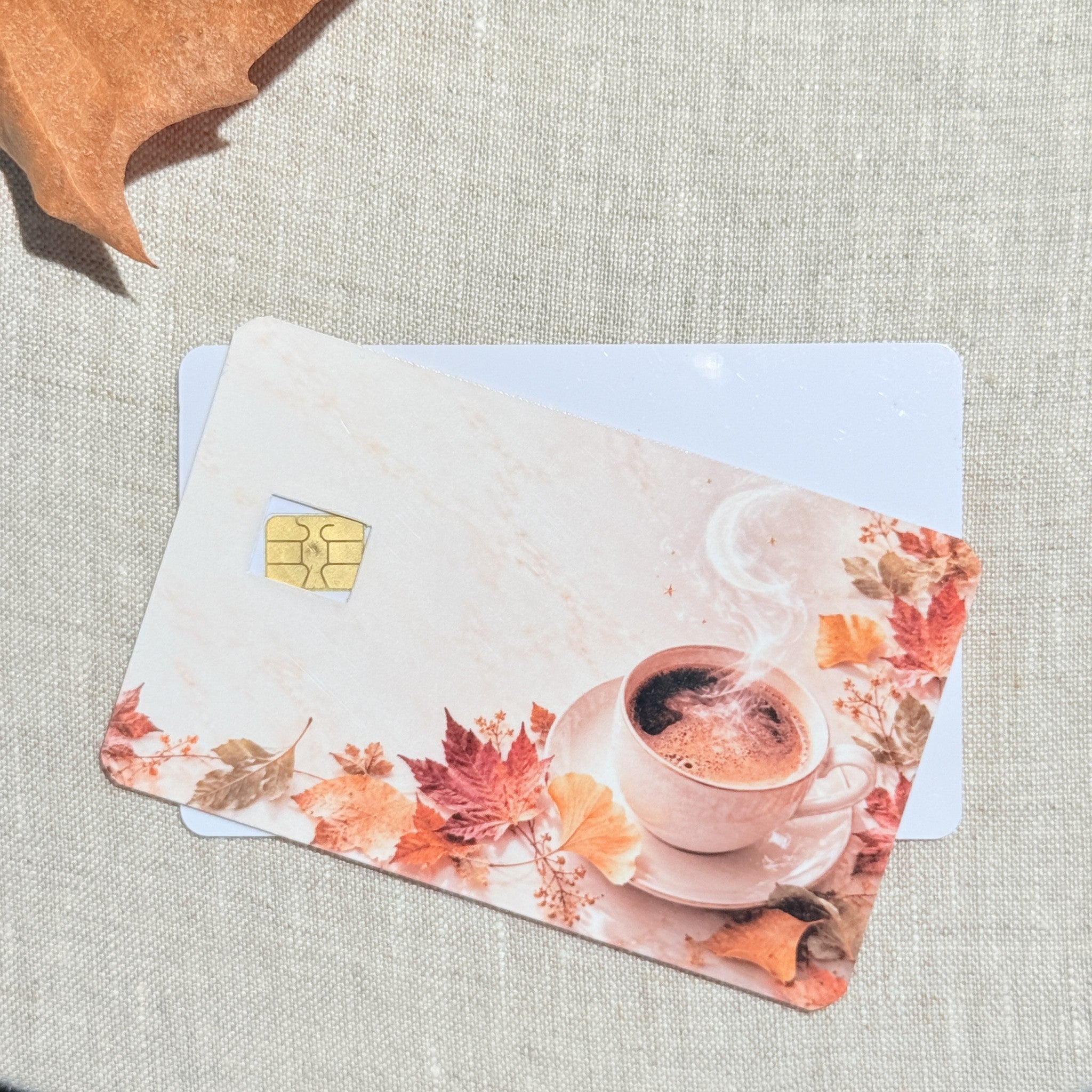 Two pumpkin spice latte card skins stacked to show the standard and sparkle finishes