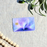 Purple magic book card skin with glowing open book on a lavender debit card by The Sticker Era