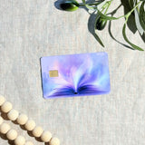 Close-up of pages fanning into purple light on the card skin by The Sticker Era
