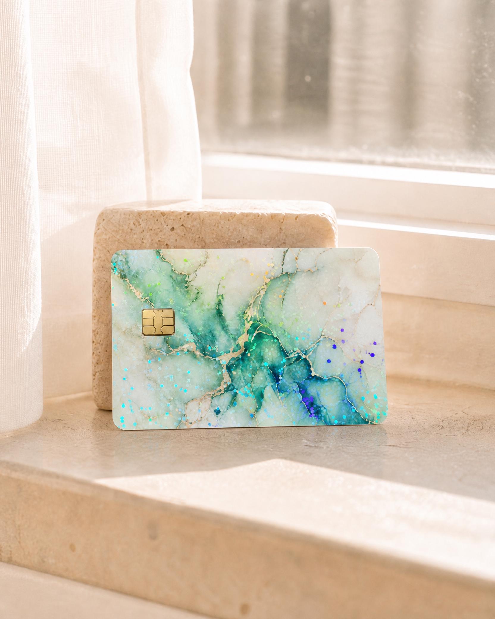 Hand holding the sage green marble card skin at a card reader by The Sticker Era