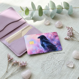 Whimsigoth raven credit card skin with eucalyptus and dried flowers on linen by The Sticker Era