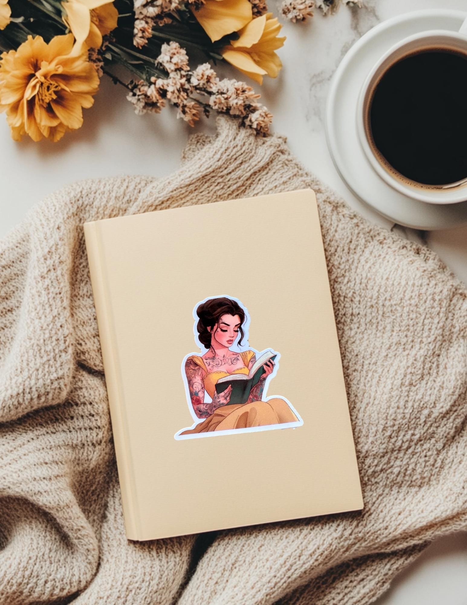 Tattooed princess reading sticker styled flat lay by The Sticker Era