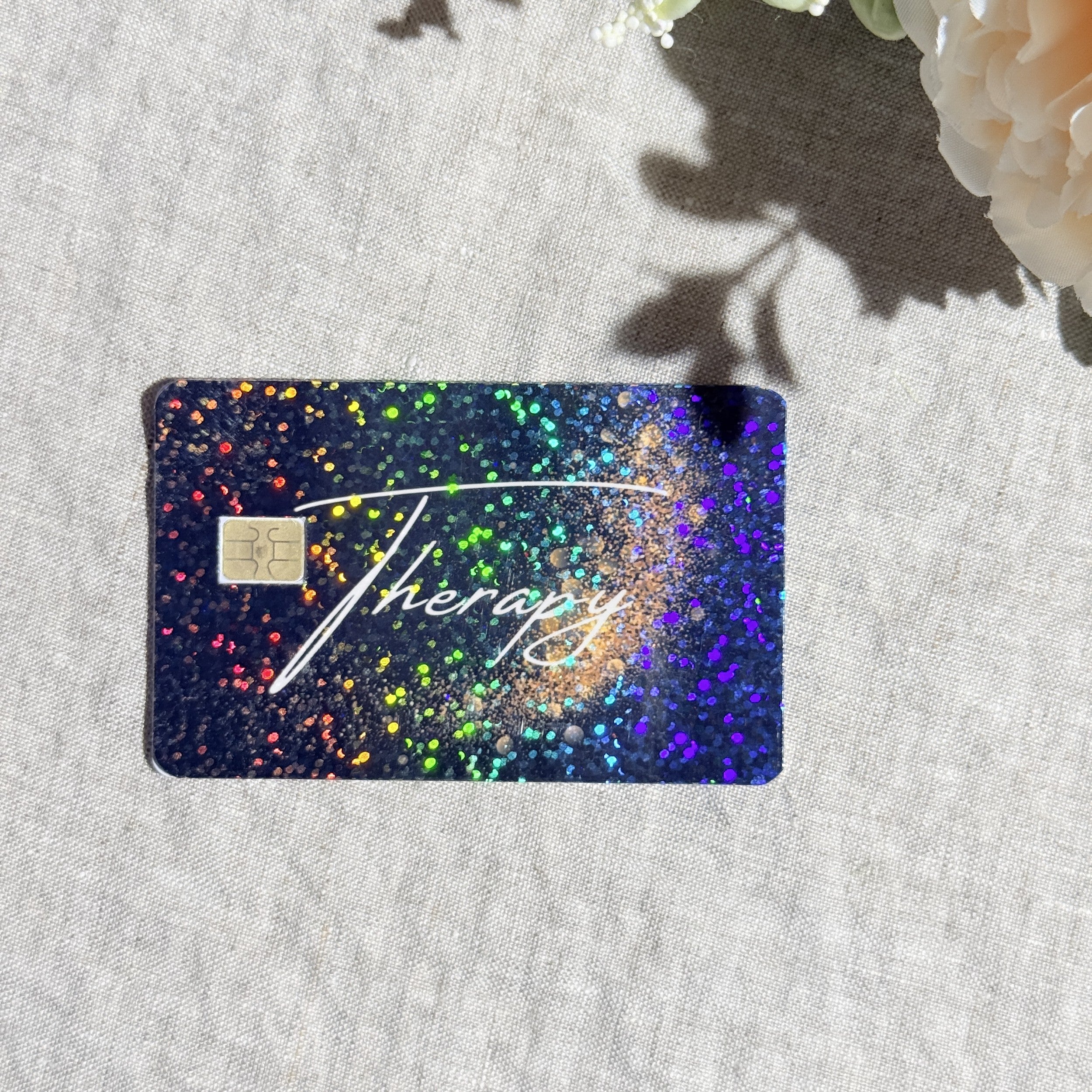 Close-up of gold dust and rainbow sparkle on the Therapy card skin by The Sticker Era