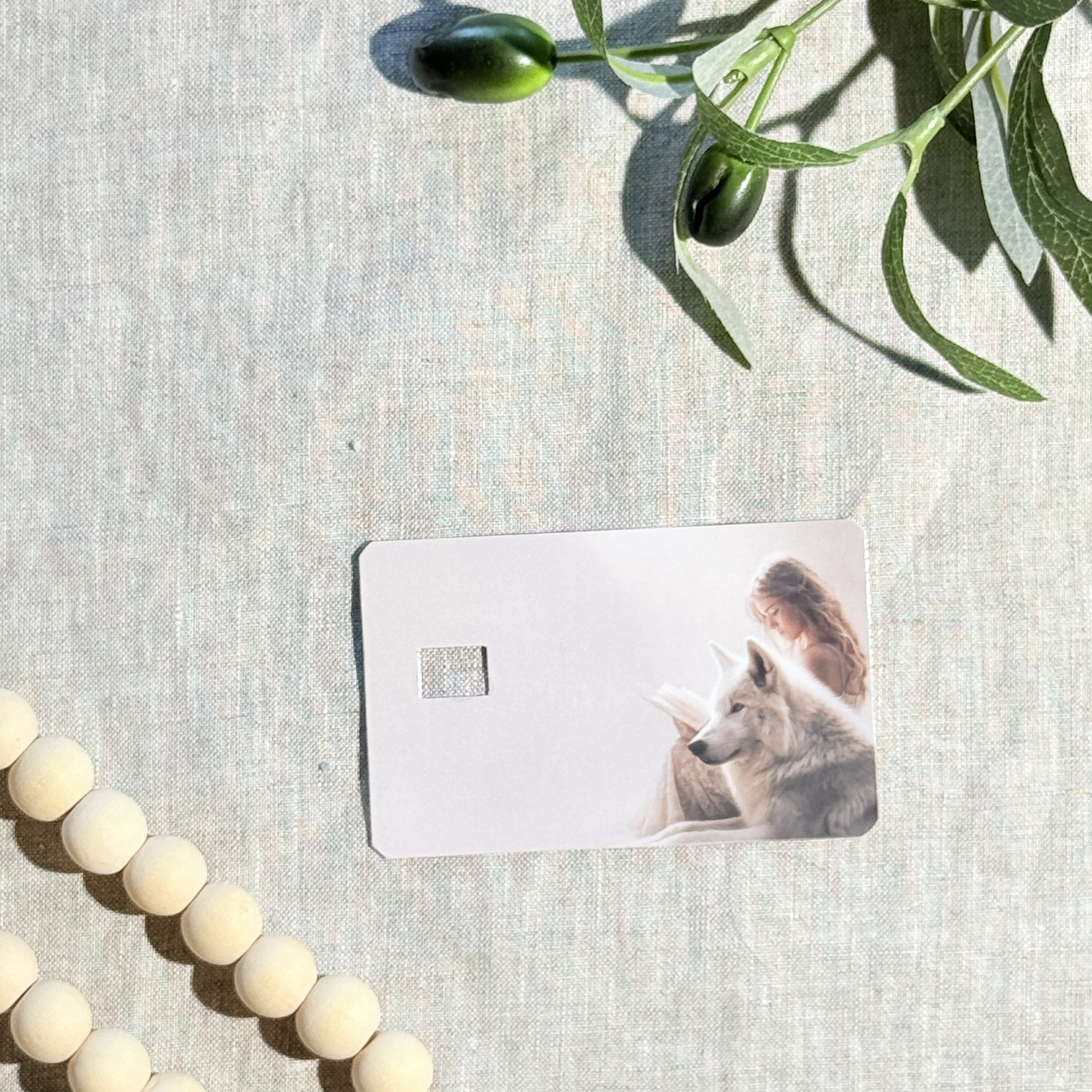Hand holding the girl reading with wolf card skin in sunlight by The Sticker Era