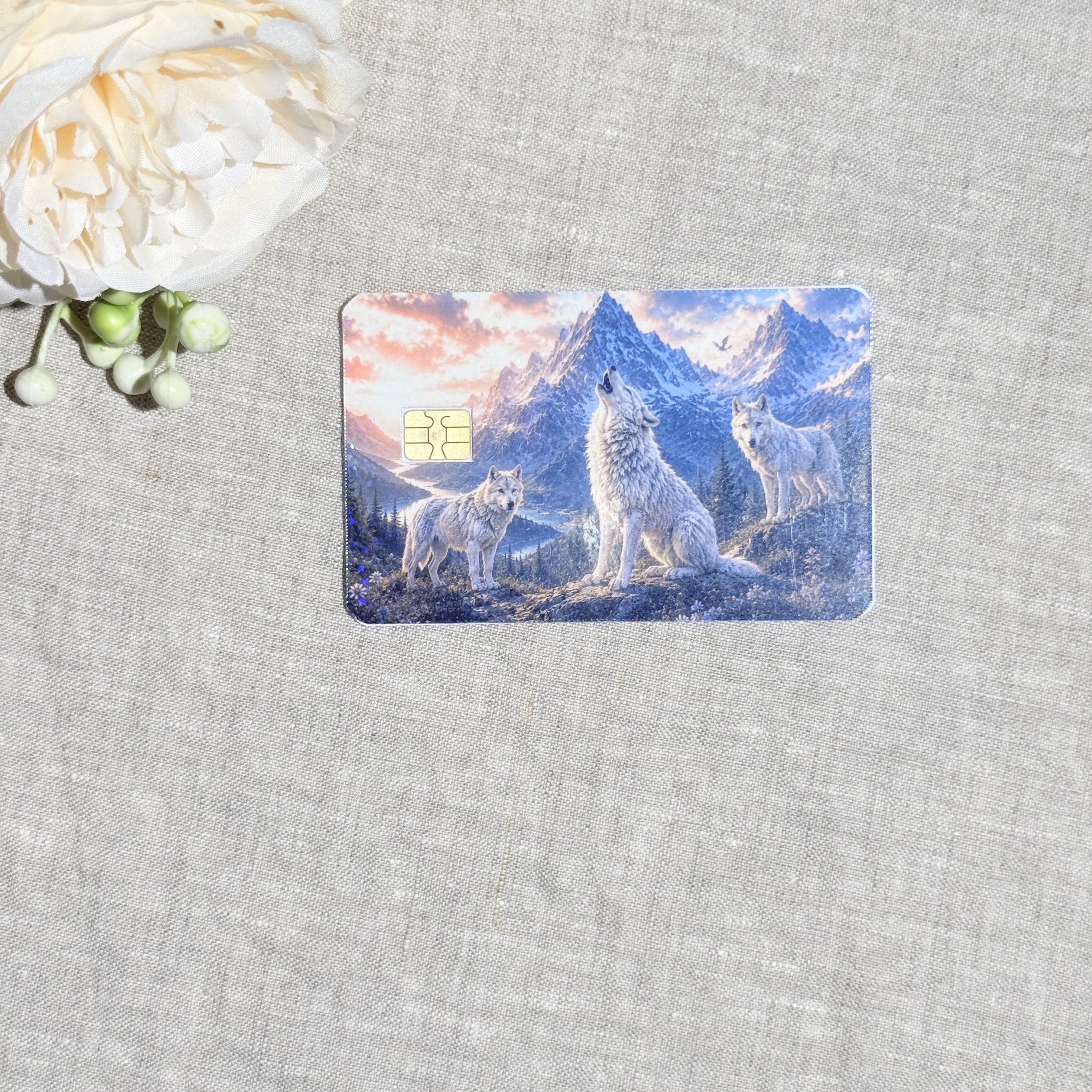 Howling white wolves mountain card skin flat lay on cream linen by The Sticker Era